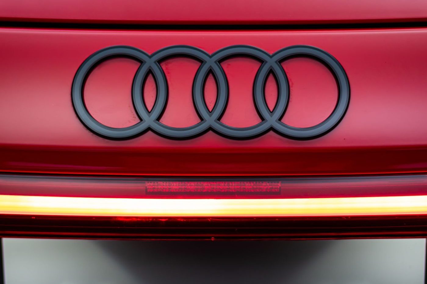 Audi rings and RS e-tron GT lettering on a red electric car