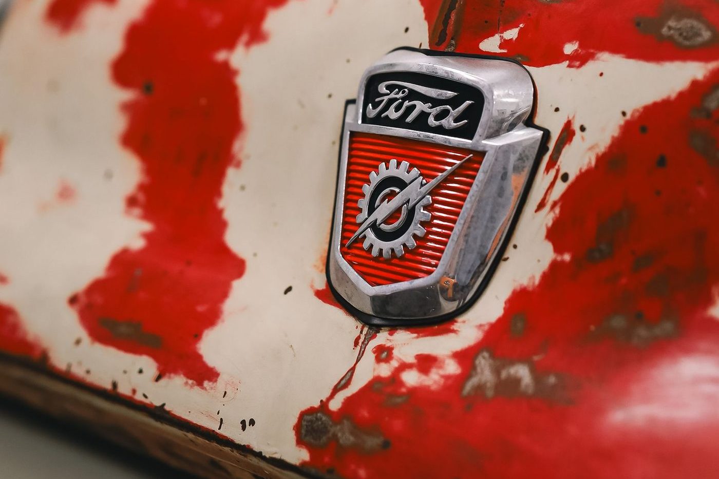 Ford crest badge on a weathered vintage car