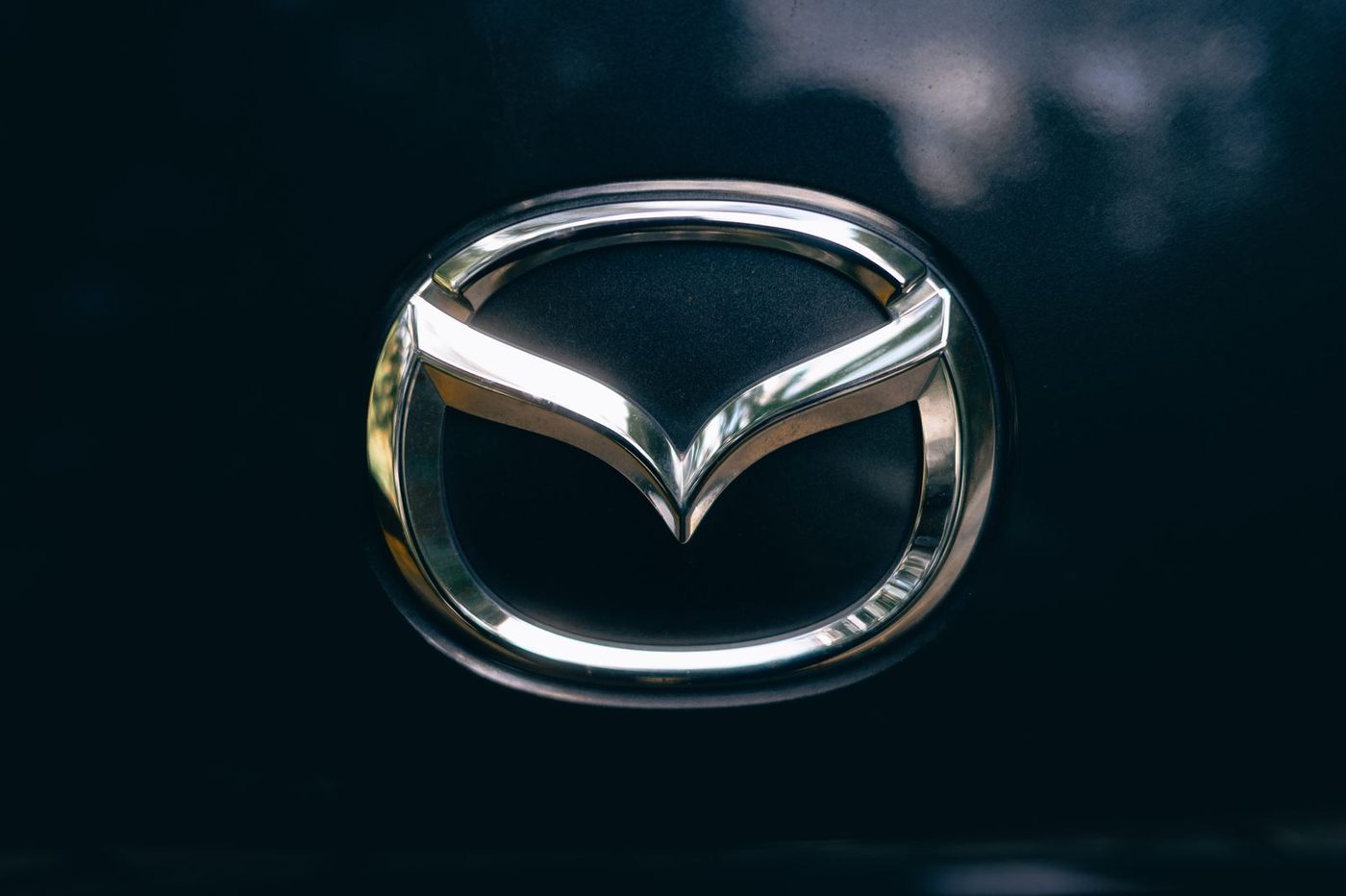 Close-up of the chrome Mazda winged M emblem