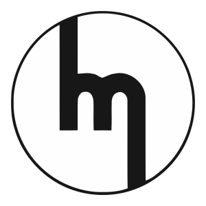 Mazda badge from 1959: a stylised lowercase m in a circle