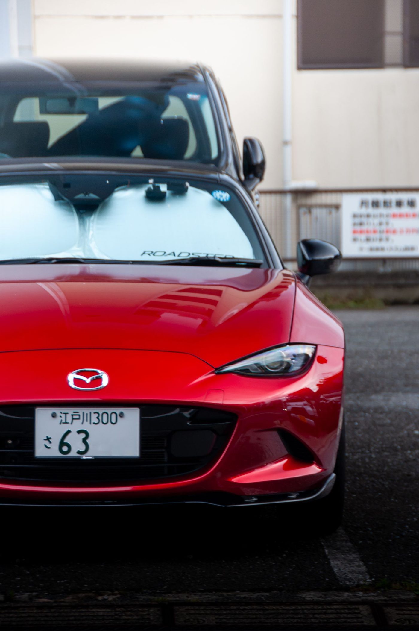 Red fourth-generation Mazda MX-5 on a street in Tokyo