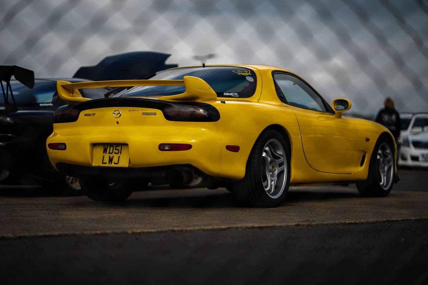 Yellow third-generation Mazda RX-7 at a car show