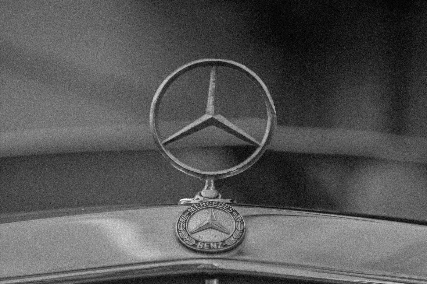Mercedes-Benz three-pointed star above the grille of a vintage car